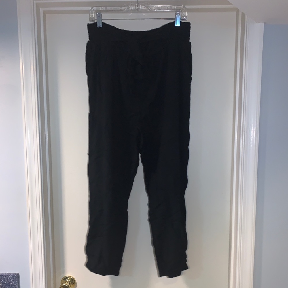 black pants tied with a bow